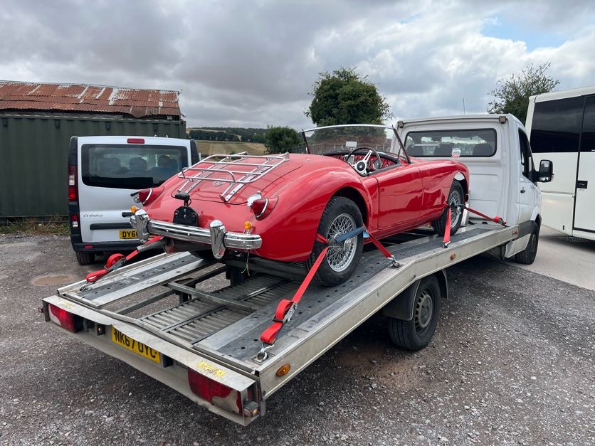 Red classic MG roadster loaded on the AL Services car transporter